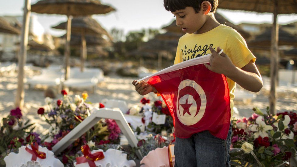 Boy with Tunisian flag on beach in Sousse, 27 June 2015