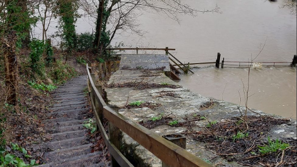 Steps leading down to Dundas Aqueduct with flood water at the bottom