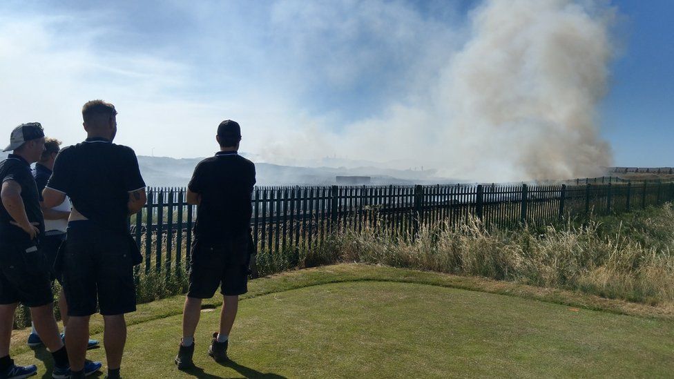 Greenkeepers watching a fire next to St Anne's Old Links