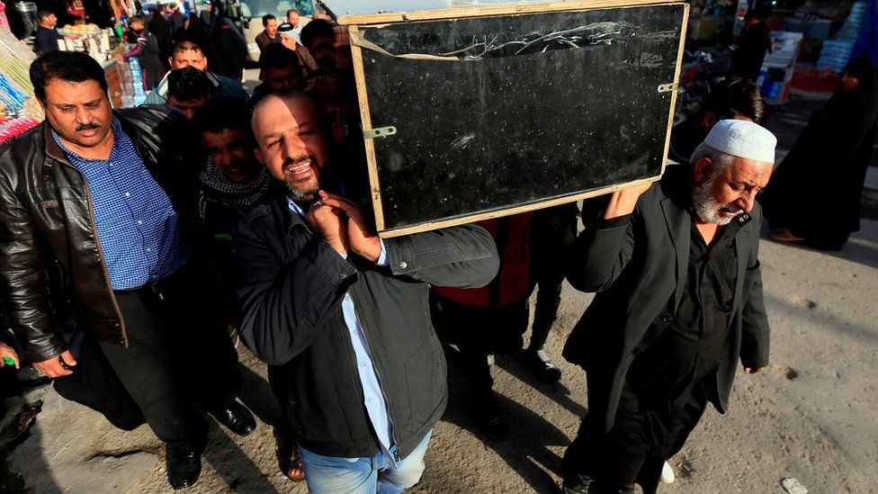 Iraqis carry the coffin of a victim during a funeral in the holy city of Najaf, Iraq, 15 January