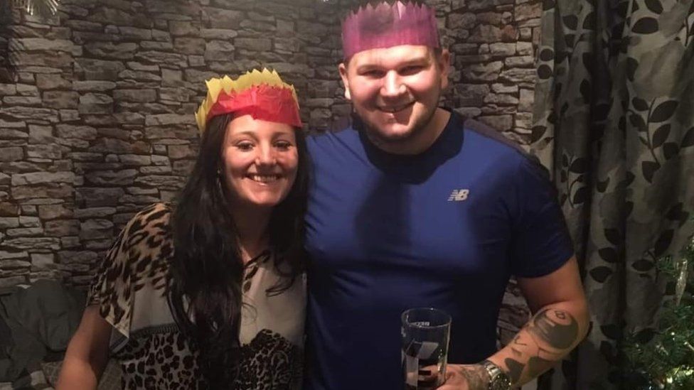 Jordan Turner with her brother Lee Turner wearing party hats and smiling