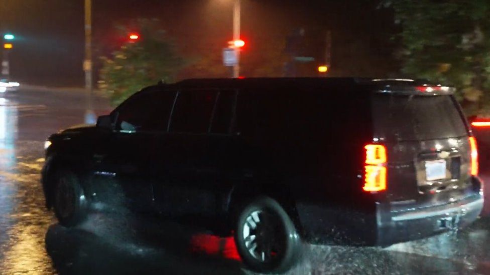 A car carrying the chancellor leaves a building in Washington DC