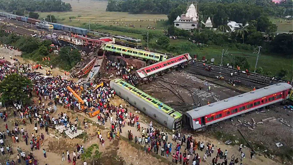 This screen grab made from AFPTV video footage taken on June 3, 2023 shows people gathering at the accident site of a three-train collision near Balasore, about 200 km (125 miles) from the state capital Bhubaneswar in the eastern state of Odisha.