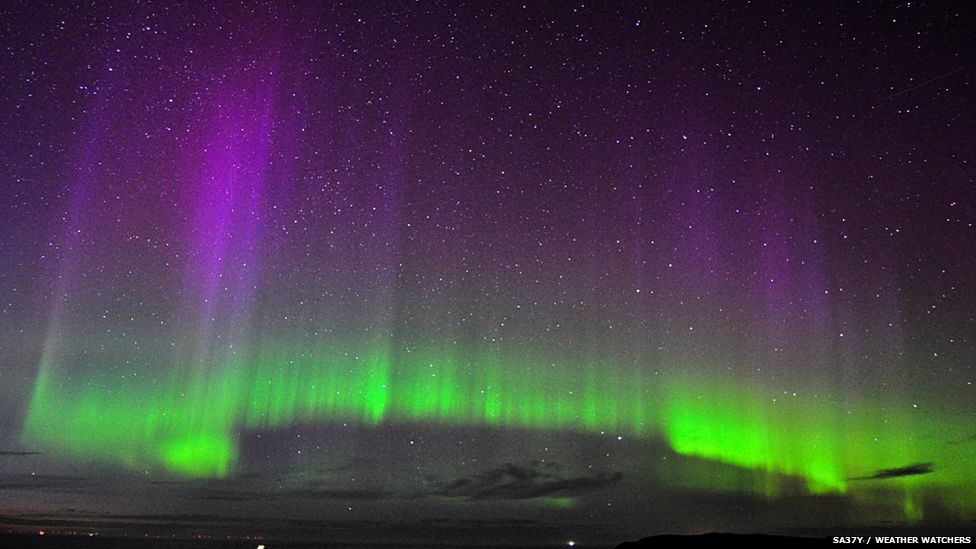 Aurora made up of bright green with purple streaks above
