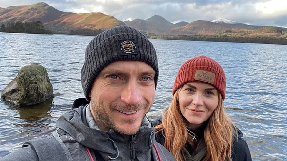 Robert Robson and his partner take a selfie in front of a lake