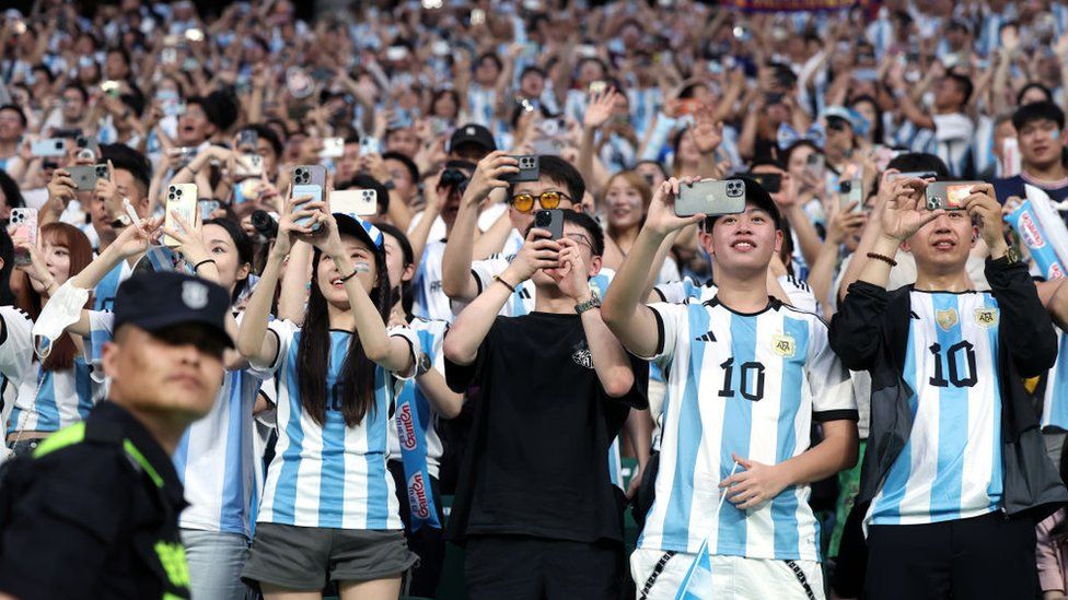 Fans in Messi jerseys at the Workers' Stadium