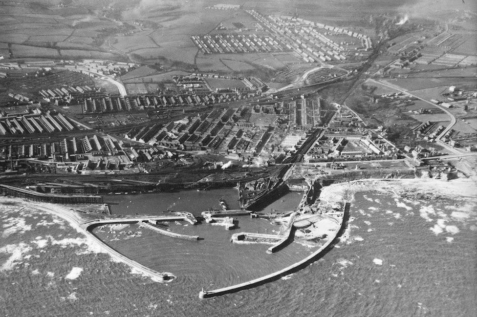 Aerial black and white view of Seaham harbour with the town beyond