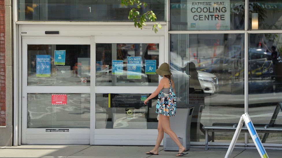 A woman enters a cooling centre during the scorching weather of a heatwave in Vancouver