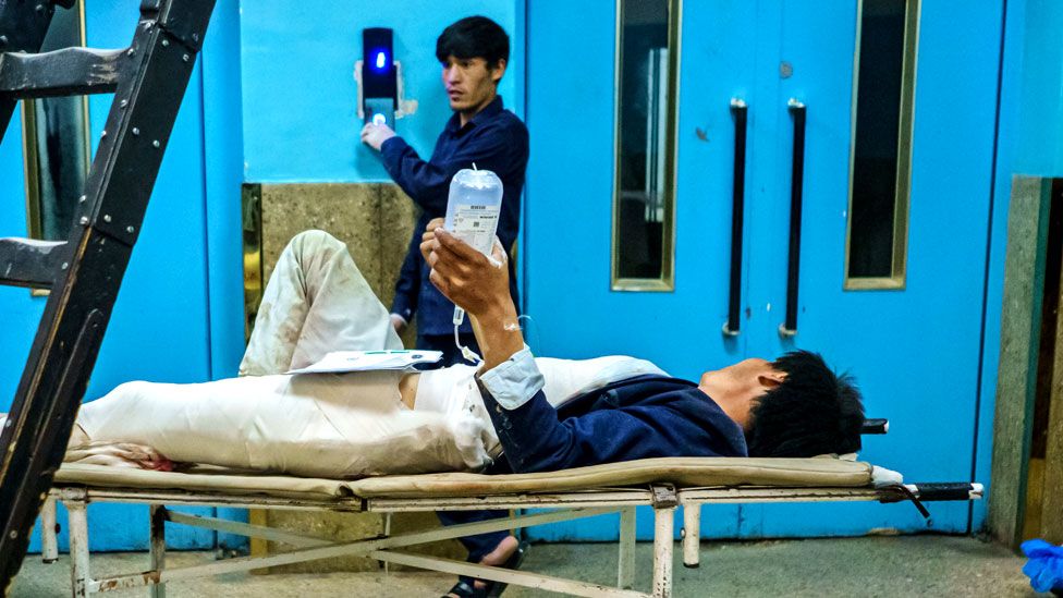 A wounded patient lays in the hallway to be transported to another floor at Wazir Akbar Khan Hospital. in Kabul, Afghanistan, on 26 August 2021