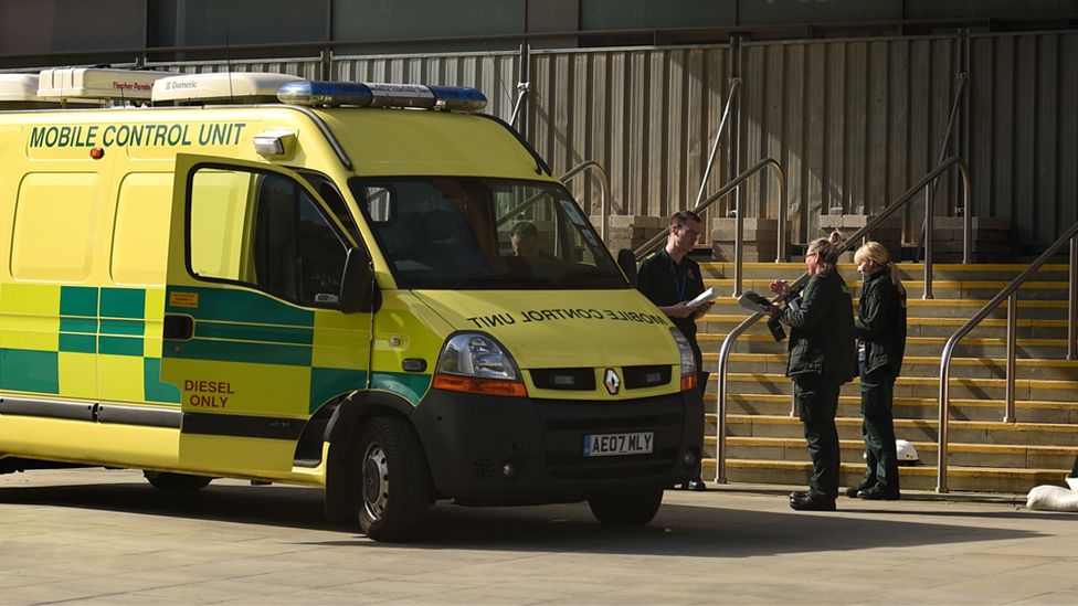 North West Ambulance Service staff work outside the "Nightingale Hospital North West", the converted Manchester Central Convention Complex, in Manchester, north-west England on 13 April 2020
