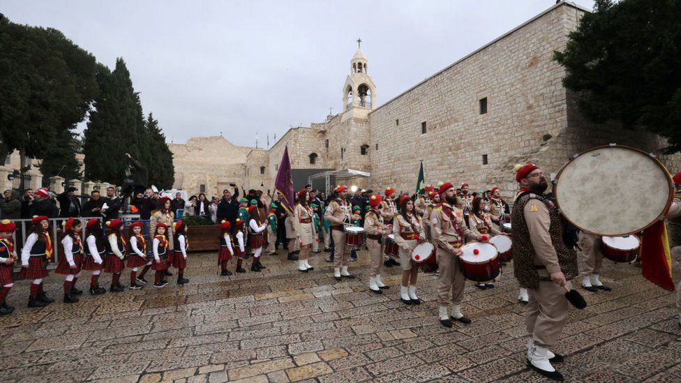 Palestinian scouts march outside the Nativity Church