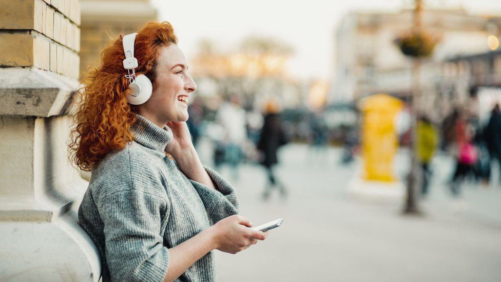 Woman listening to a podcast