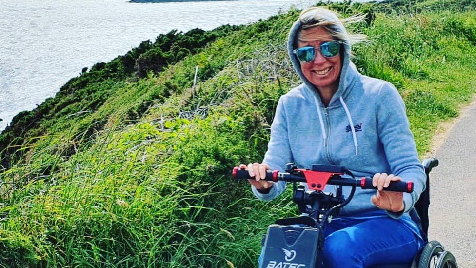 Amanda Harris on mobility scooter on coastal path