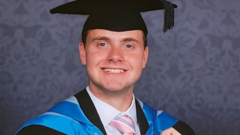 A young man in a graduation outfit