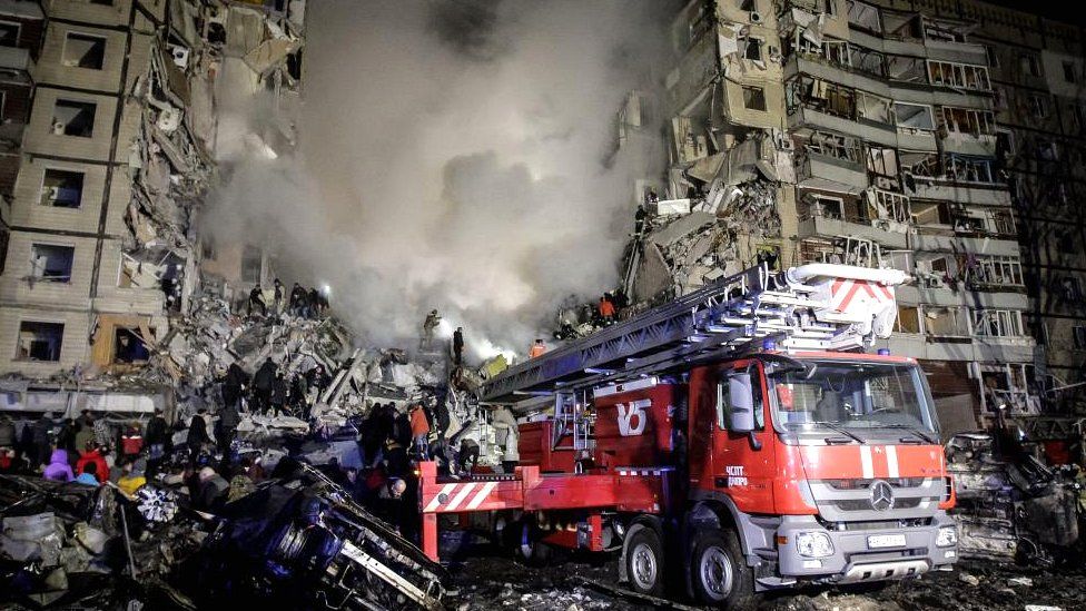 Rescue team works among the rubble of a damaged residential building hit by shelling in Dnipro, south-eastern Ukraine, on 14 January 2023