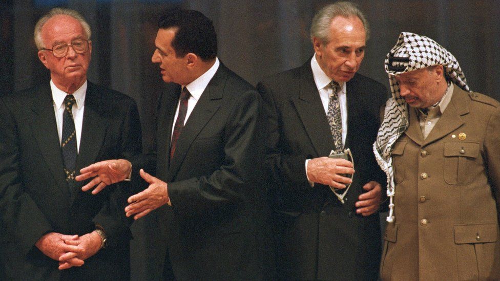 Picture dated 4 May 1994 shows Egyptian President Hosni Mubarak (2-L) speaking with Israeli Prime Minister Yitzhak Rabin (L), as Israeli Foreign Minister Shimon Peres (2-R) is talking with PLO Chairman Yasser Arafat (R) during an Israel-PLO agreement signing ceremony, in Cairo, Egypt
