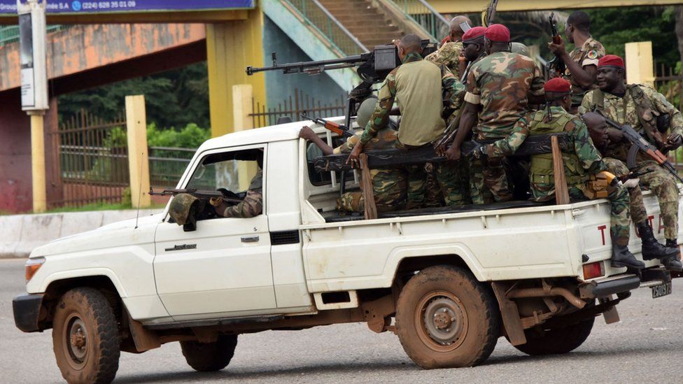 Members of the Armed Forces of Guinea drive through the central neighbourhood of Kaloum in Conakry on September 5, 2021 after sustainable gunfire was heard.