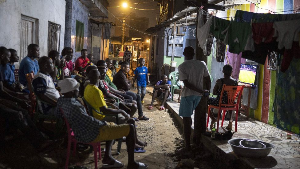 Football fans watch a match on TV in Douala, Cameroon - Monday 24 January 2020