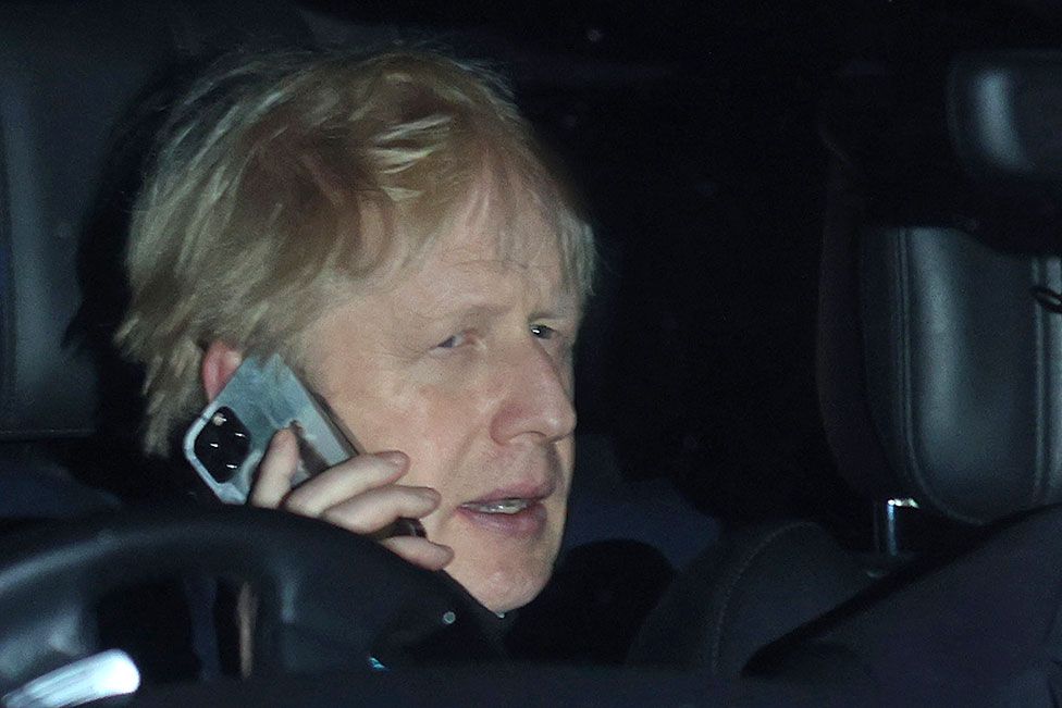 Boris Johnson on the phone while returning to 10 Downing Street by car