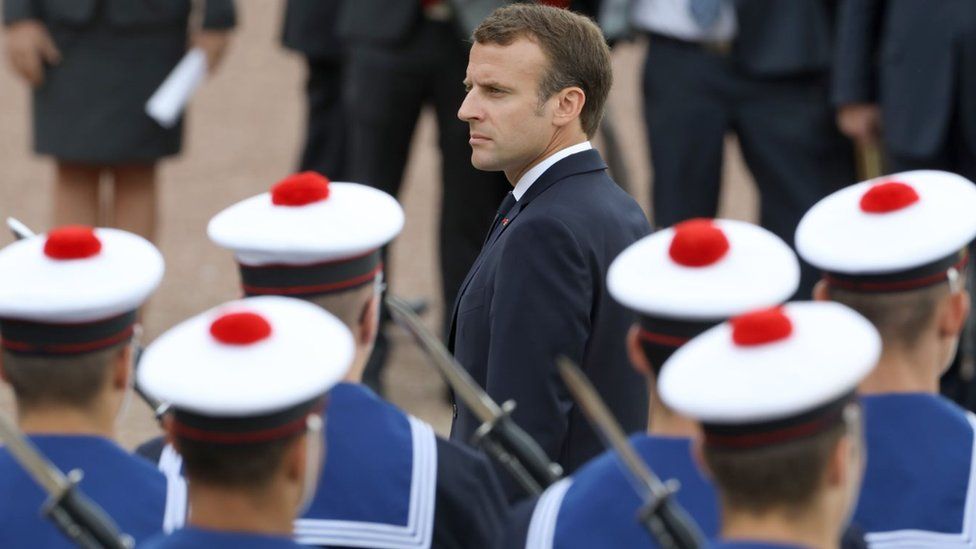French President Emmanuel Macron reviews a troop of French navy soldiers during a ceremony commemorating General Charles De Gaulle's June 1940 appeal to French resistance against Nazi Germany on June 18, 2018