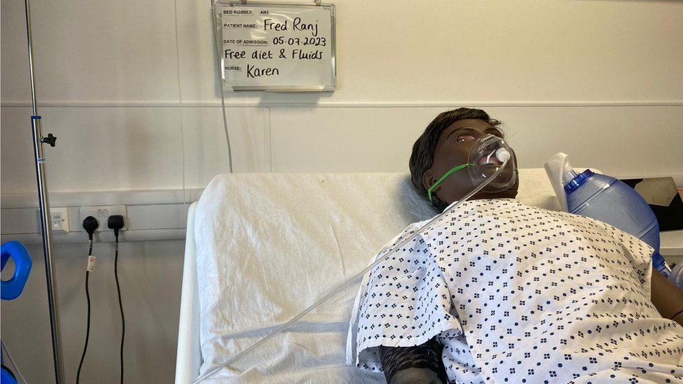 One of the mannequins, Fred, lying on a bed in the pretend ward at New College