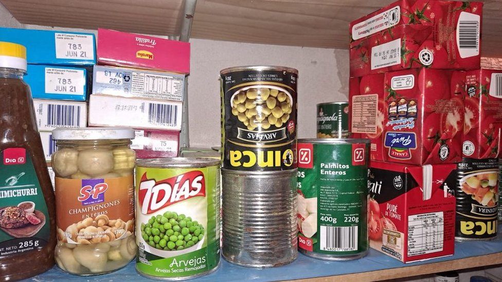 Tins and jars of food stored in Noira's spare room