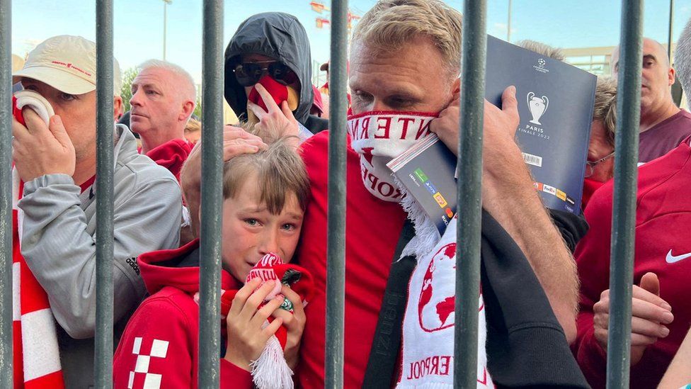 Liverpool fans react as they queue to access Stade de France before Champions League Final