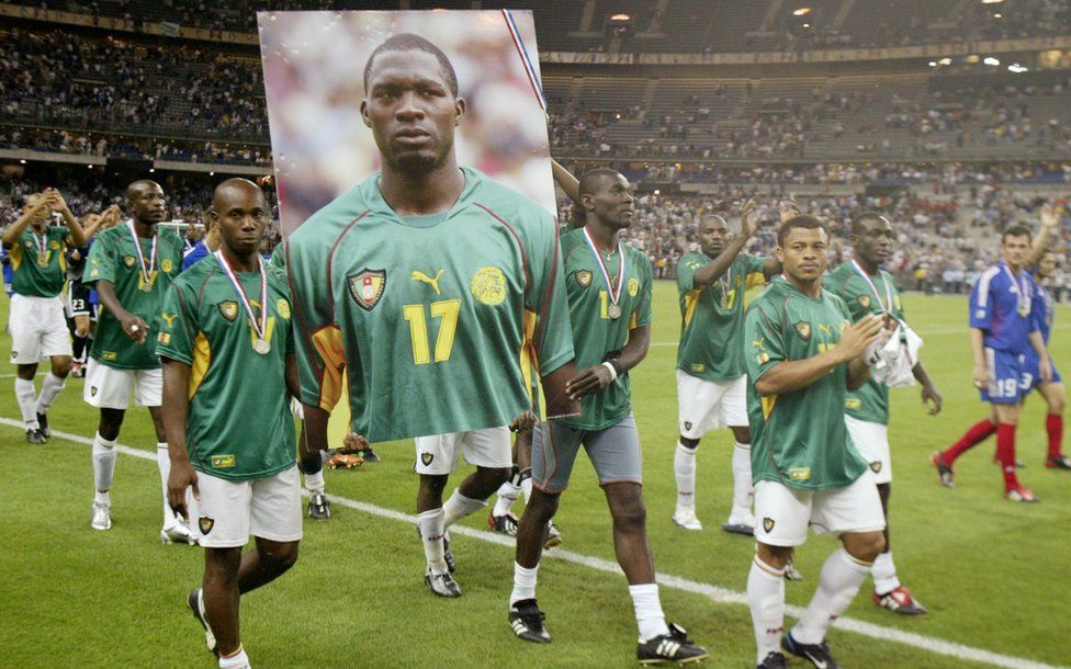 Cameroon players take a photo of Marc-Vivien Foe through the stadium, which died a few days earlier on the football field.