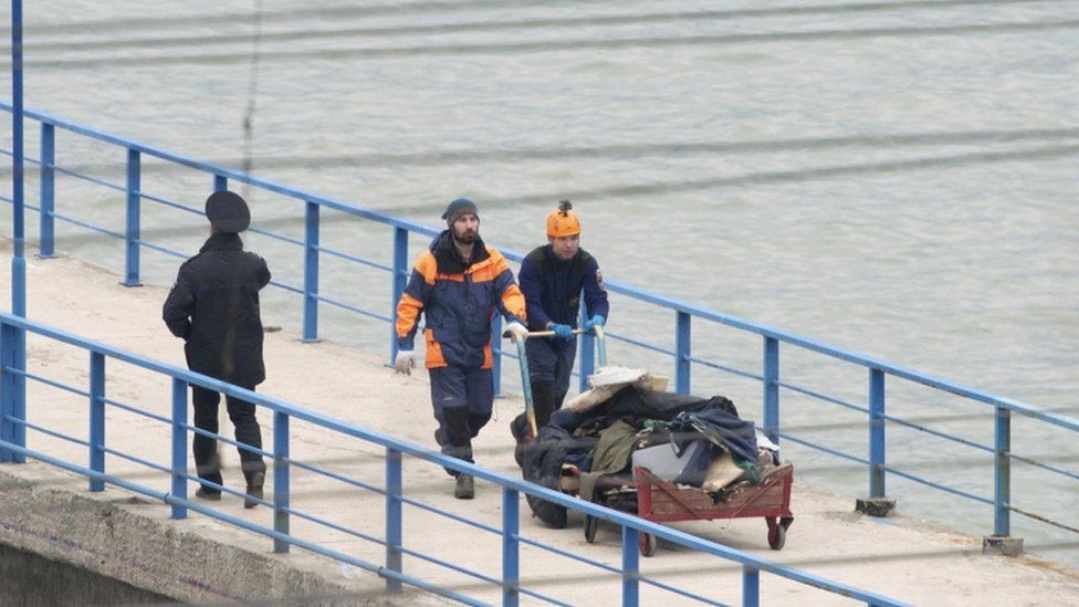 Debris from the plane is returned via a quay in Sochi