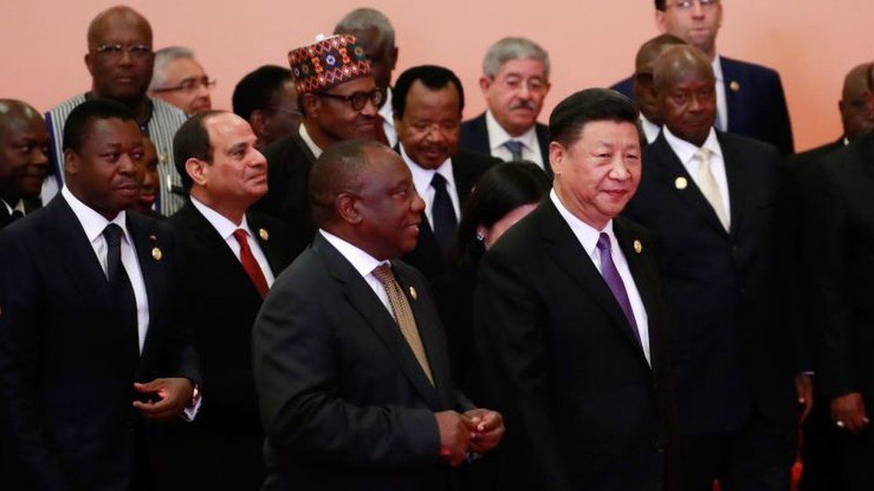China's President Xi Jinping walks infront of African leaders