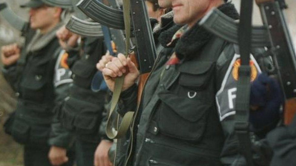 Members of the Kosovo Liberation Army hold their weapons in this 1999 picture