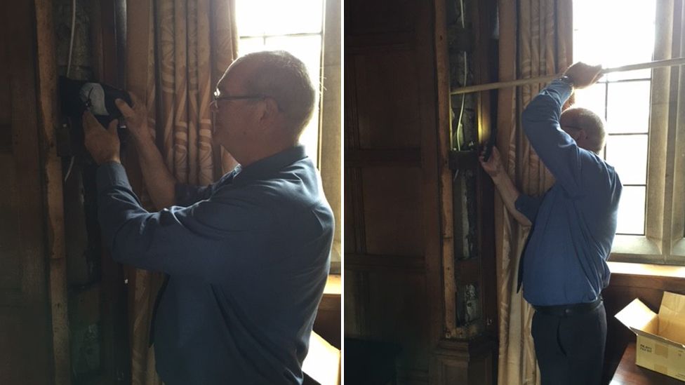 Steve Beeby placing shoe behind panelling at St John's College