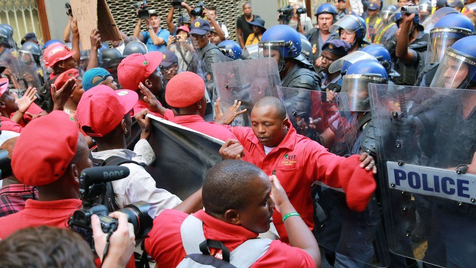 South African anti-riot police officers clash with members of South Africa's radical leftist Economic Freedom Fighters (EFF) party
