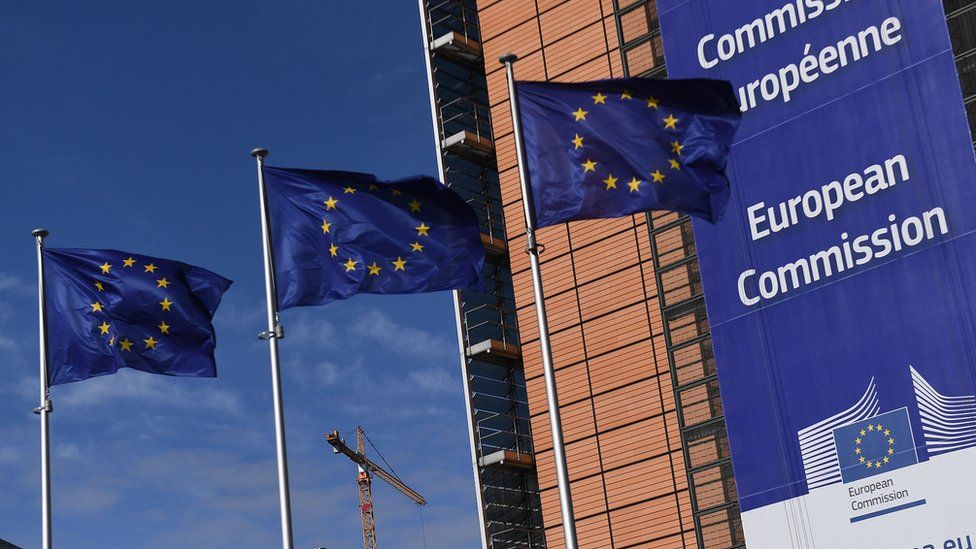 European Union flags next to the European Commission headquarters in Brussels