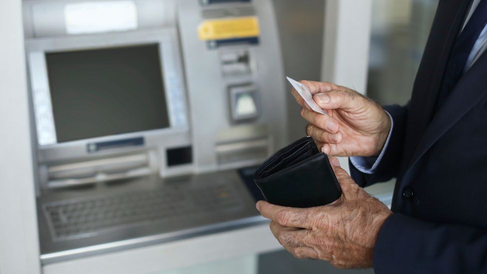 Elderly man using an ATM