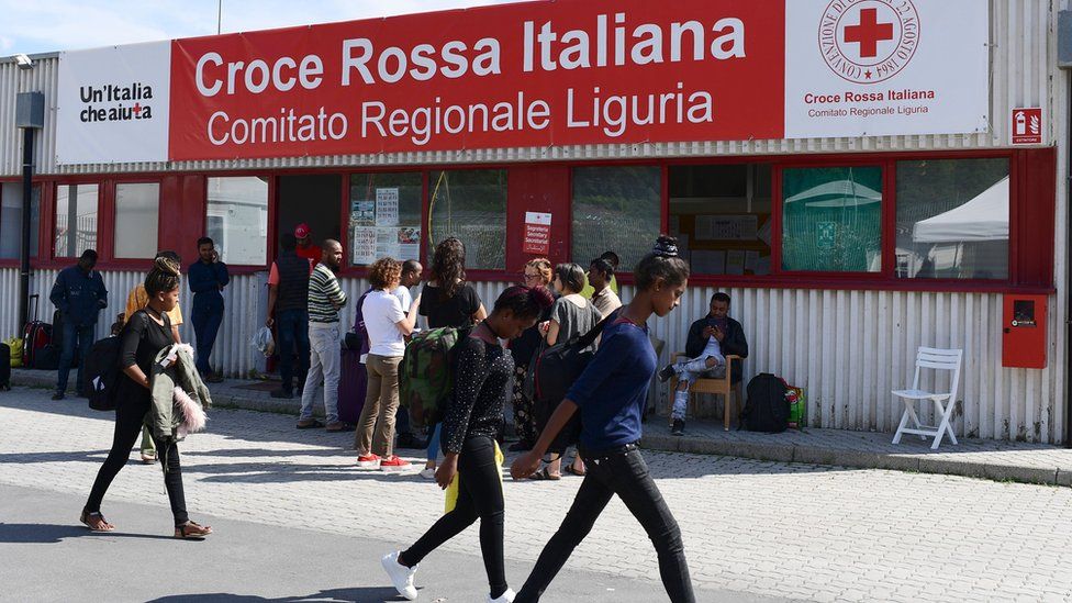 Migrants walk at the Italian Red Cross camp in Ventimiglia, northern Italy, on June 15, 2018