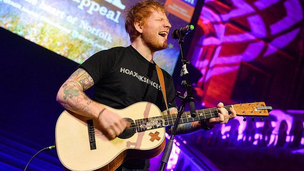 Ed Sheeran performing at a charity gala