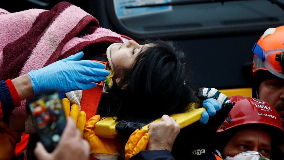 Rescuers carry a young girl on a stretcher at the site of a collapsed residential building in the Kartal district, Istanbul, Turkey, 7 February 2019