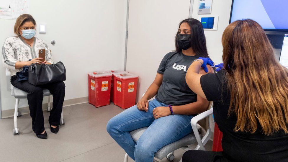 A 16-year old receives a dose of the Pfizer vaccine.