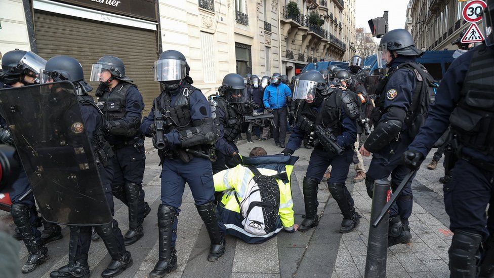 Police apprehend one protester in Paris.