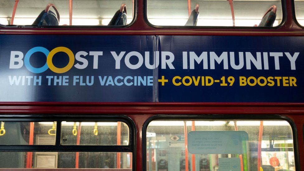 Public health advice bus advert in Birmingham suggesting people should "Boost your immunity with the flu vaccine and the Covid-19 booster" from 26 November 2021