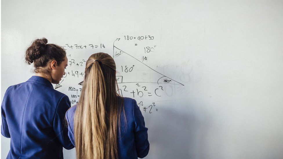 girls working on maths board