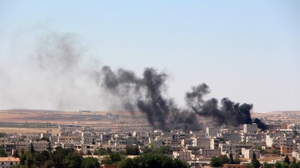 Smoke billow from the Syrian town of Kobane, 25 June