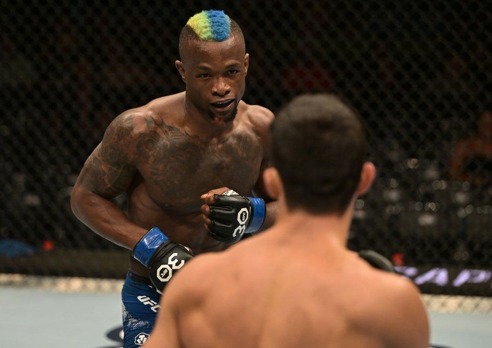 Marc Diakiese of the Democratic Republic of Congo, who has bright dyed hair, fights Kaue Fernandes of Brazil.