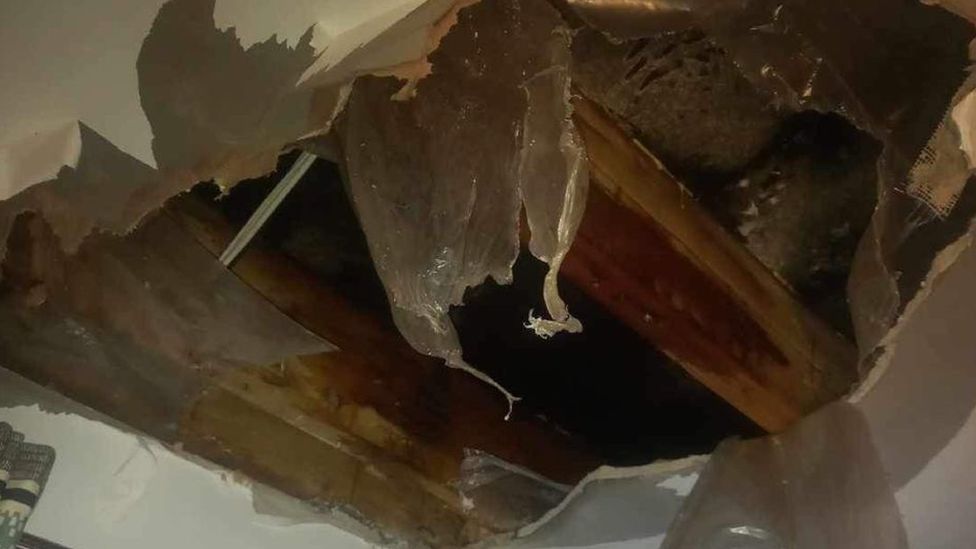 A large hole in a ceiling, caused by leak, in a house in Killaire Wood