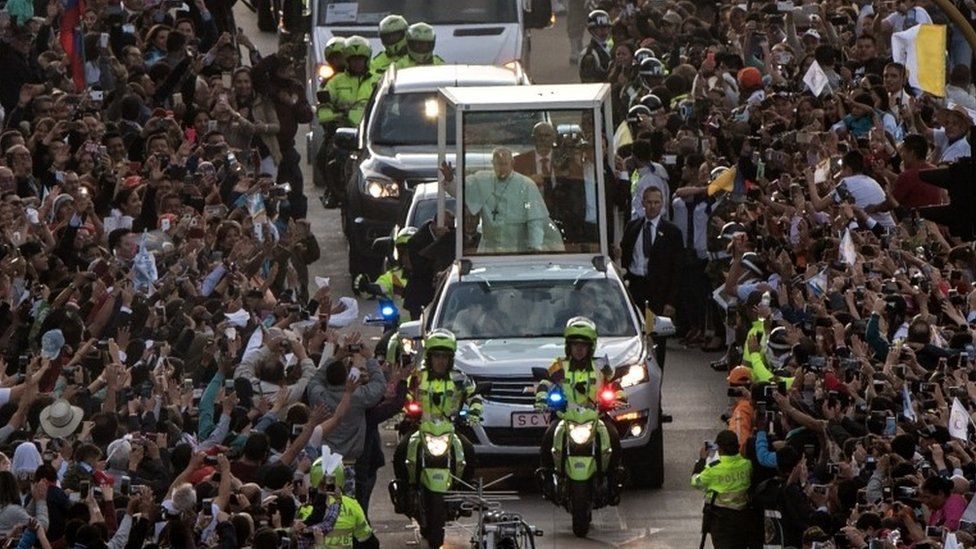 Pope Francis waves from the Popemobile, upon arrival in Bogotá on 6 September 2017.