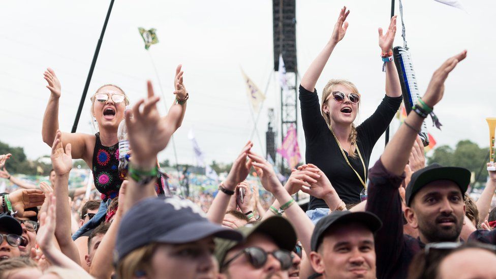 Festival-goers attend Glastonbury