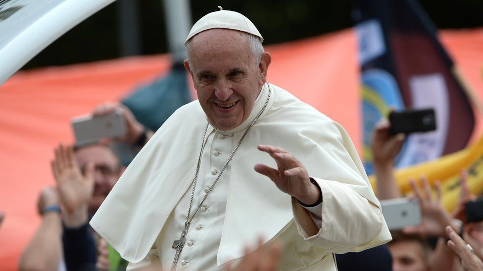 Pope Francis waves to crowds in Poland from the popemobile
