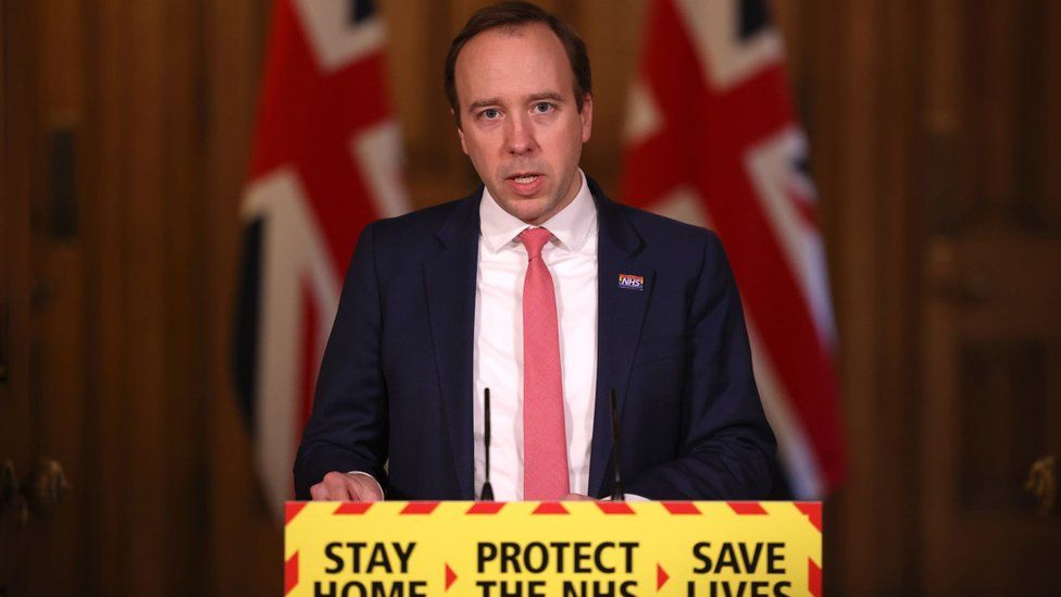 Matt Hancock stands at the 'protect the NHS' lectern