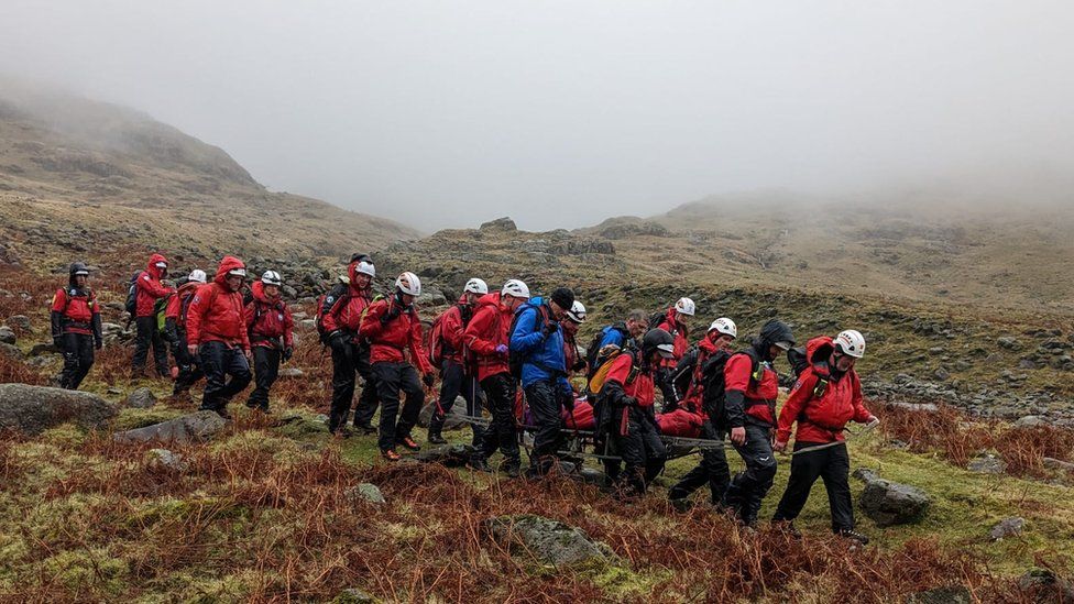 The injured walker is stretchered off the mountain by rescuers
